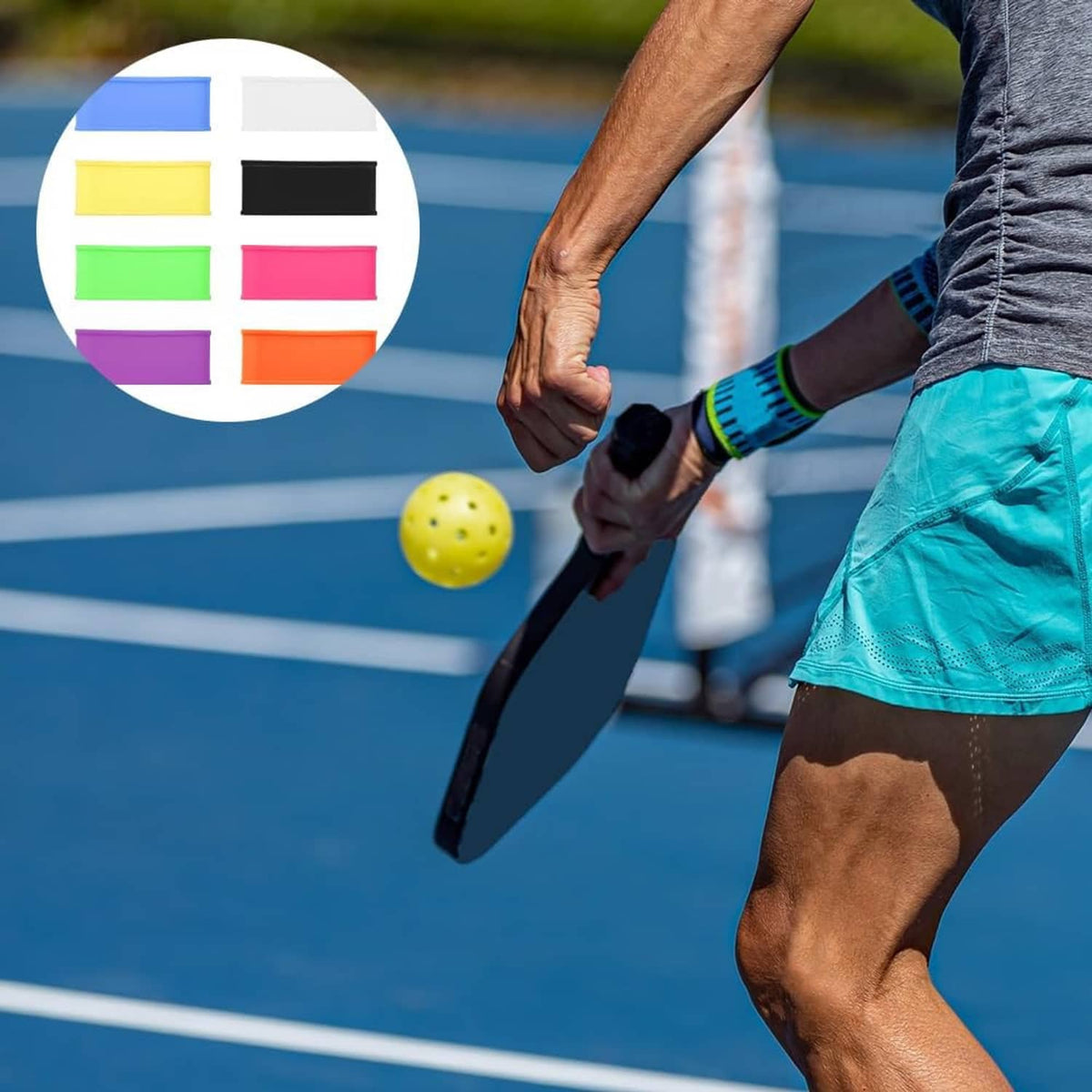 Pickleball grip sleeve on a black paddle handle with color band swatch chart