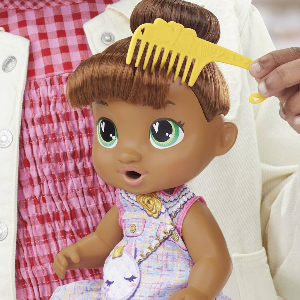 Sophia Sparkle doll being brushed with yellow comb; unicorn dress with rose emblem