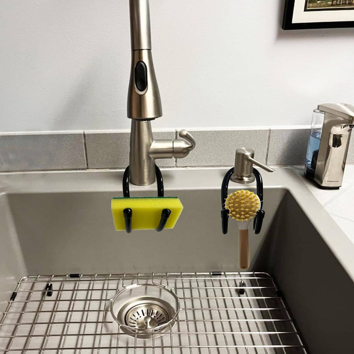 Sink-mounted sponge and scrub brush holders with yellow sponge and black hooks