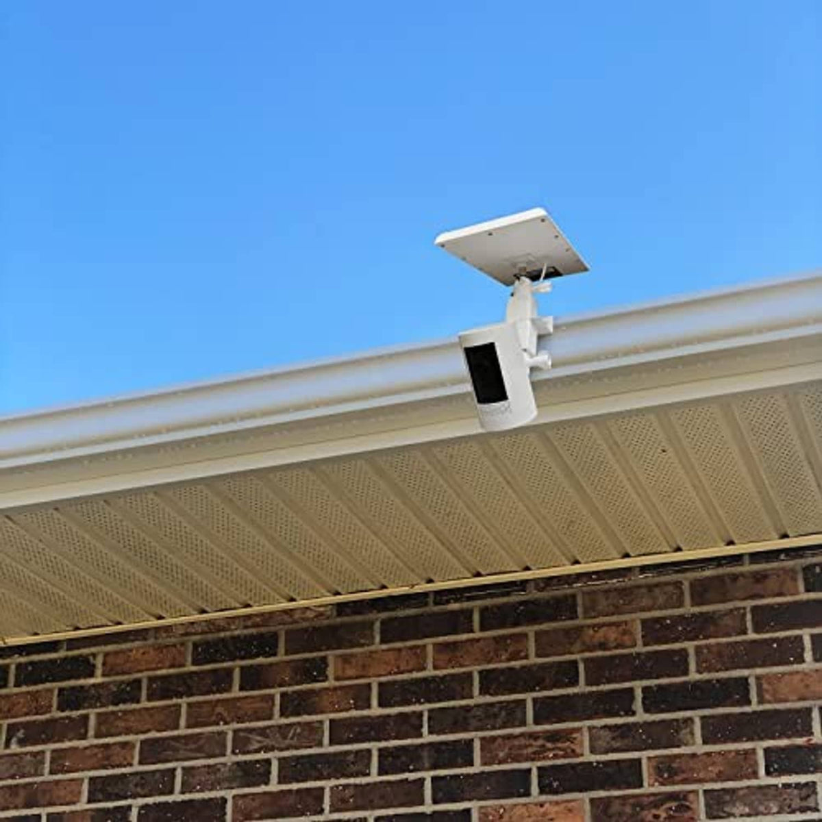 White 2-in-1 gutter mount with camera housing and solar panel bracket above