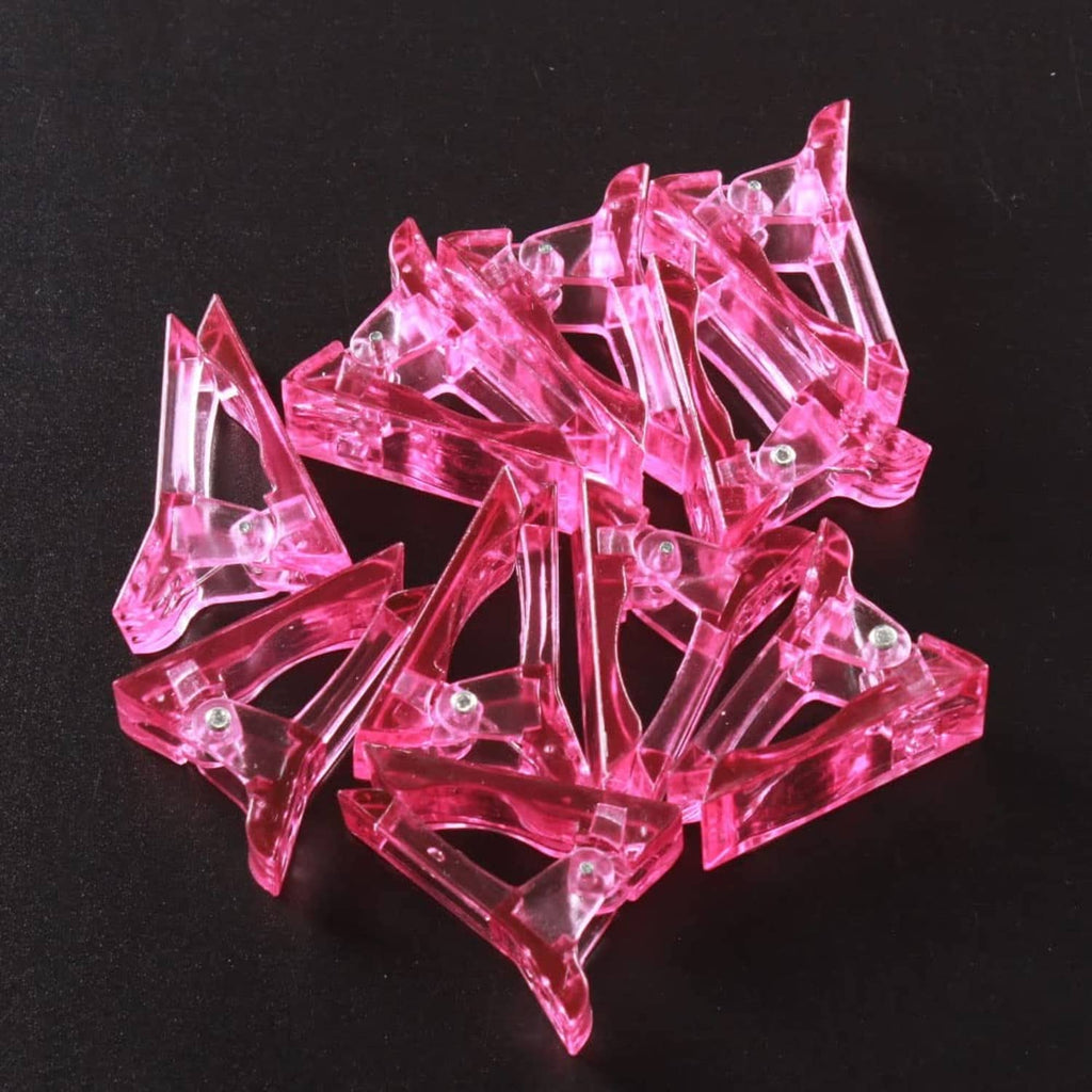 Pink crystal nail tips clips, close-up view of multiple clear prongs