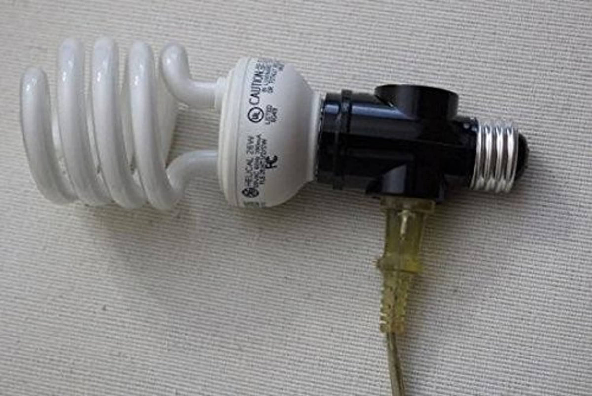 White E26 light socket to plug converter with black adapter body and exposed wires.