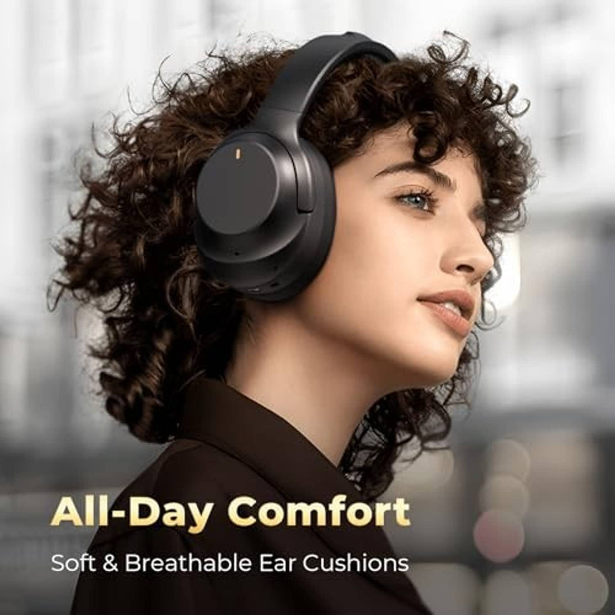 Woman wearing black over-ear headphones with soft cushioned ear cups