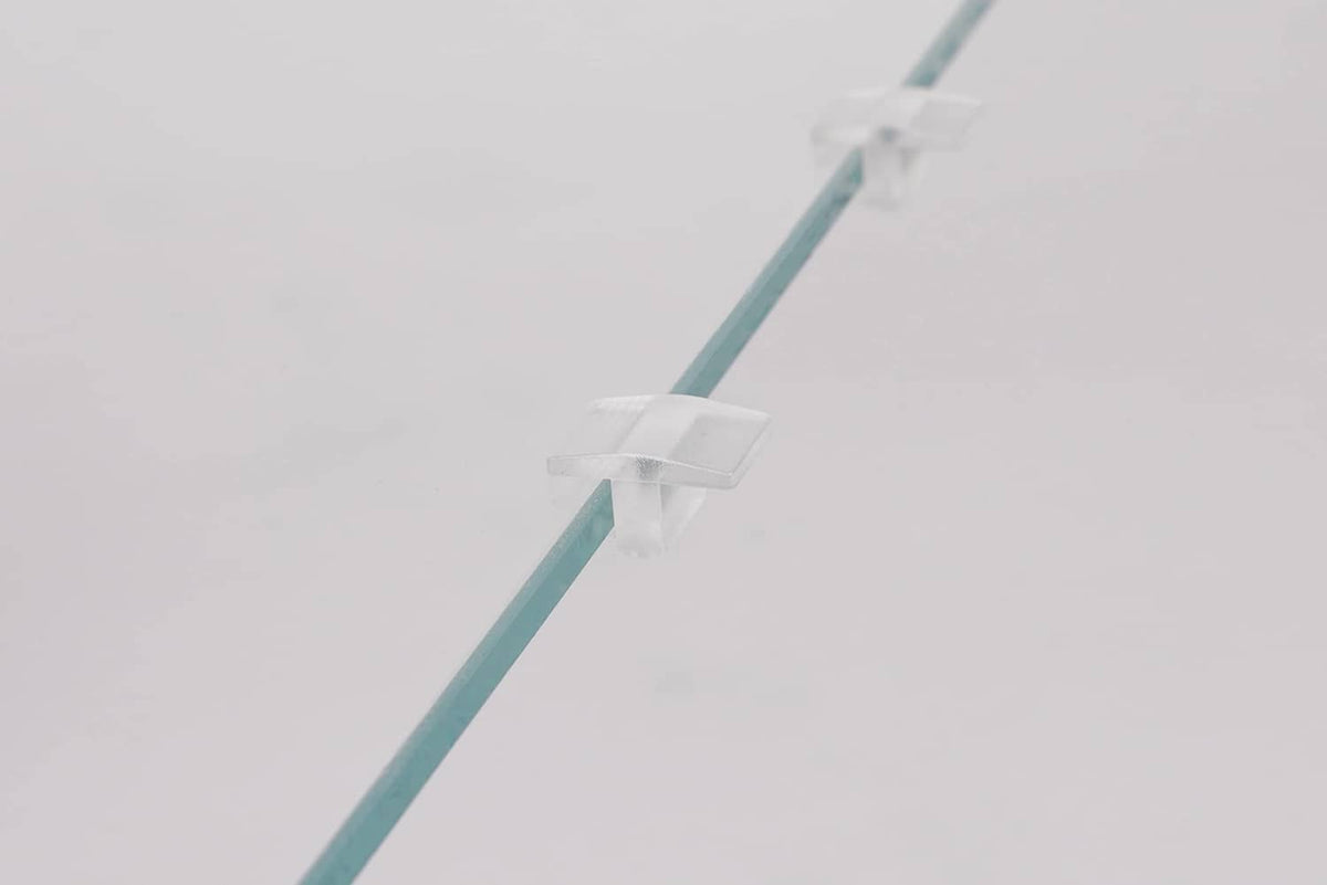 Clear acrylic lid edge spacer strip with white clips, angled view