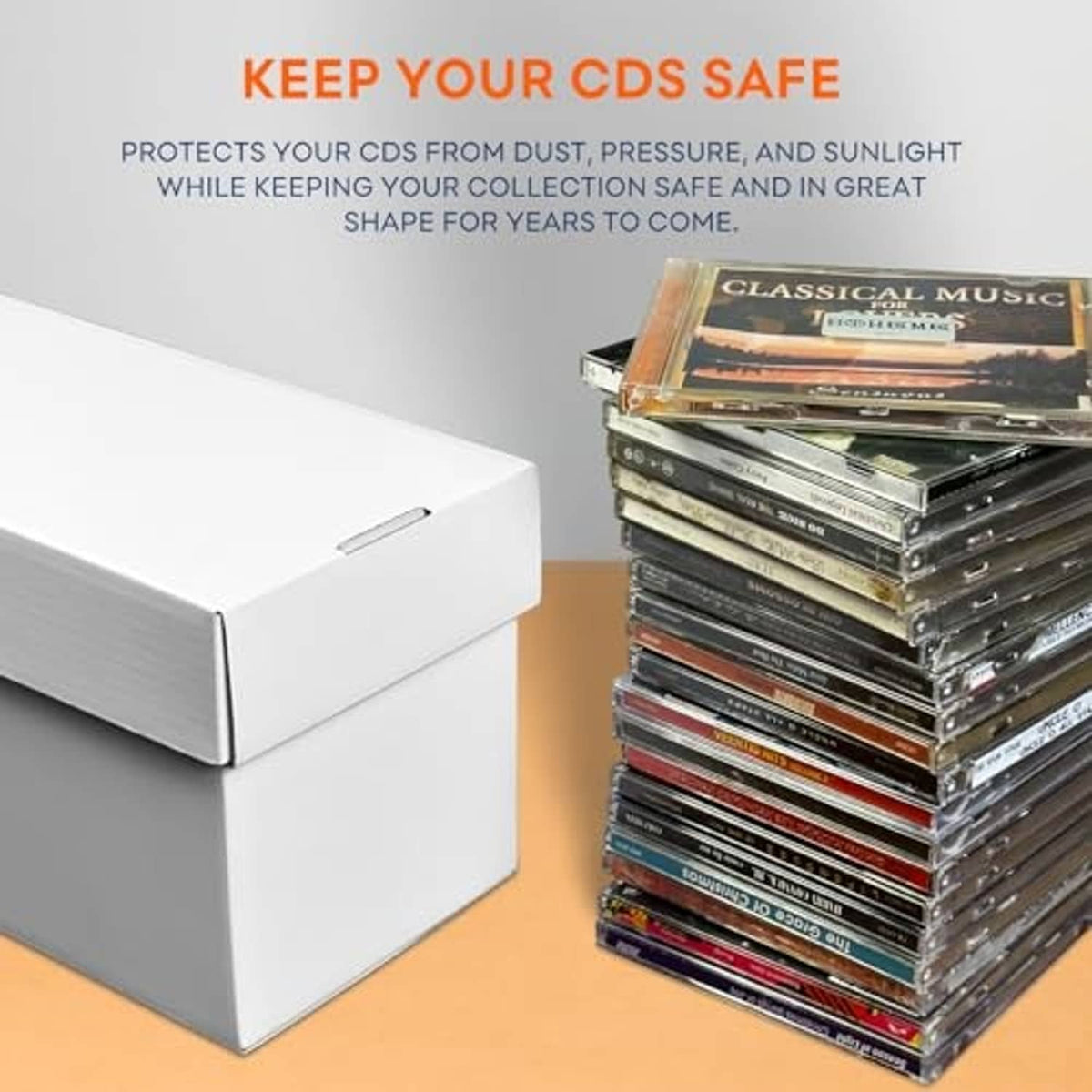 White cardboard CD storage box with lid closed and stacked CDs beside it