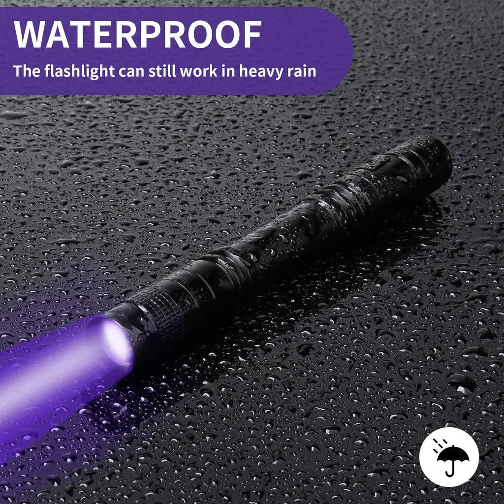 Waterproof black UV pen flashlight on wet surface with purple UV glow