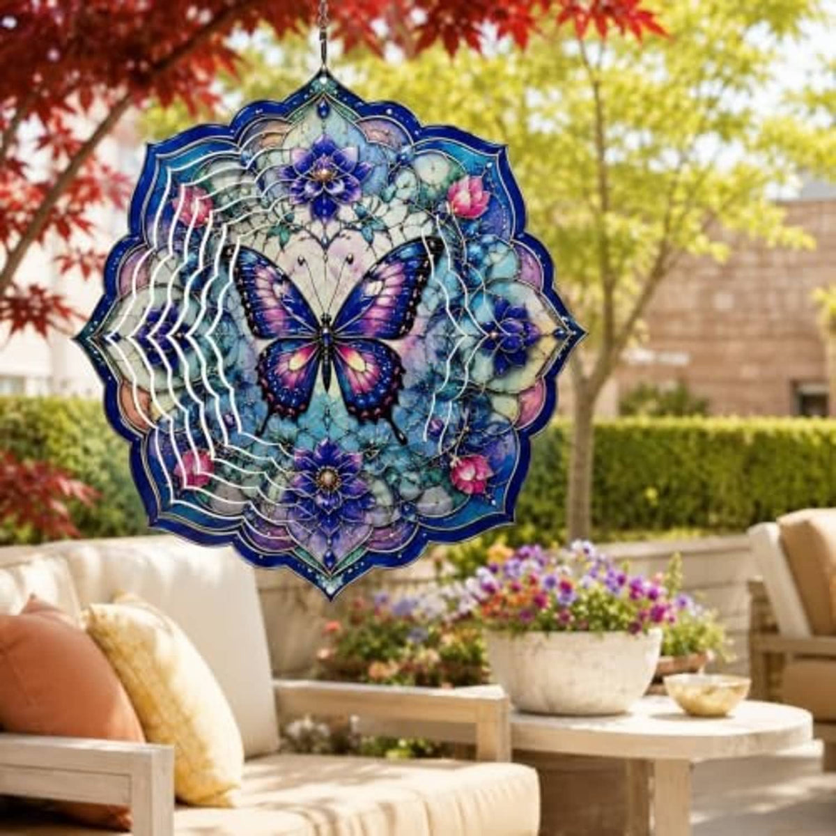 Hanging butterfly wind spinner in purple and blue with layered floral mandala details