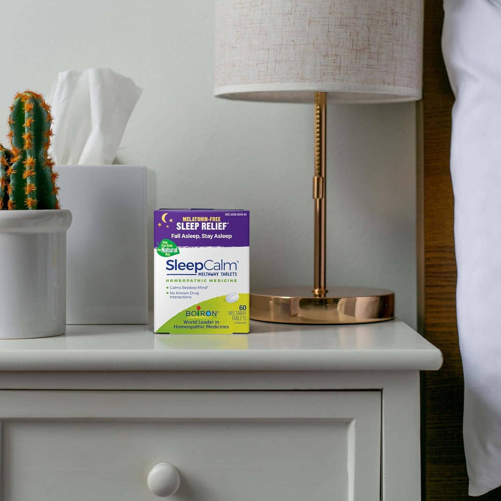 Sleep relief tablets box on a bedside table with lamp base and tissue box