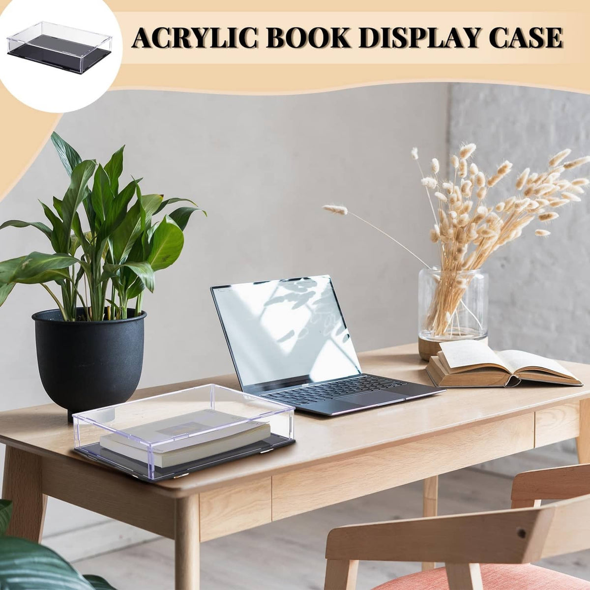 Clear acrylic book display case with black base on a desk