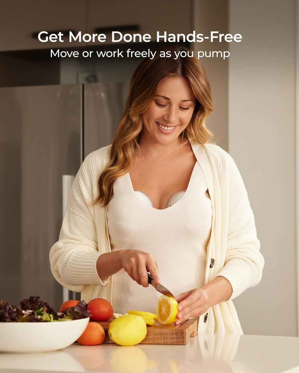 Woman wearing a hands-free wearable breast pump while preparing food, white pump cup