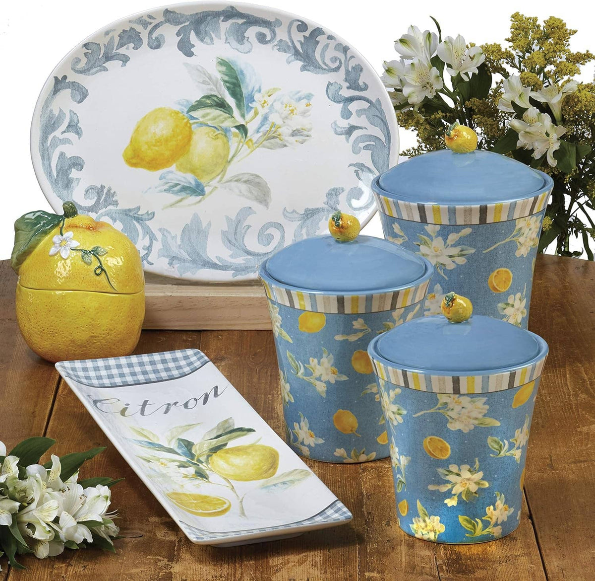 Lemon-themed ceramic storage container set with blue sides, yellow fruit, and white lid