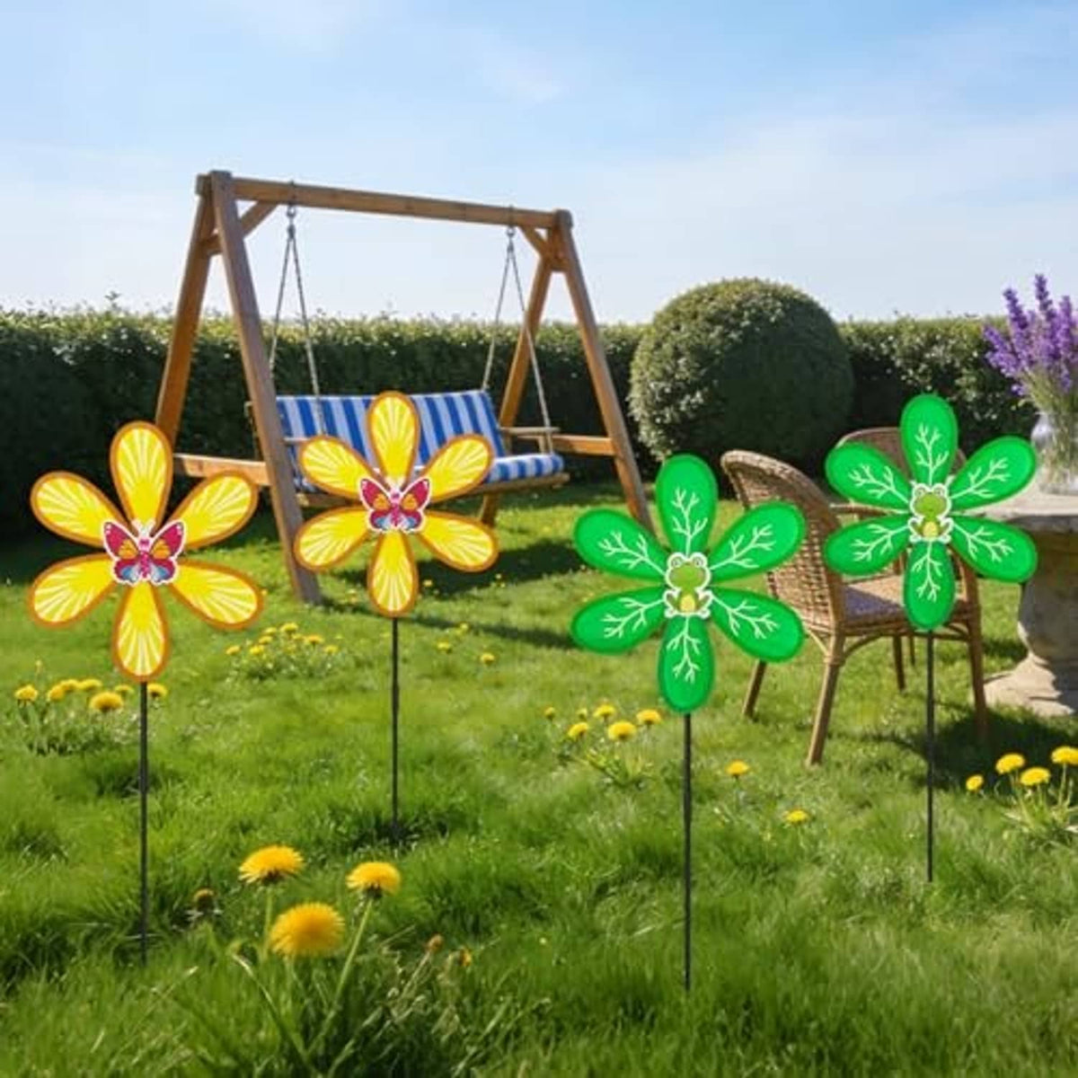 Four outdoor wind spinners with green leaf petals and yellow flower petals on black stakes