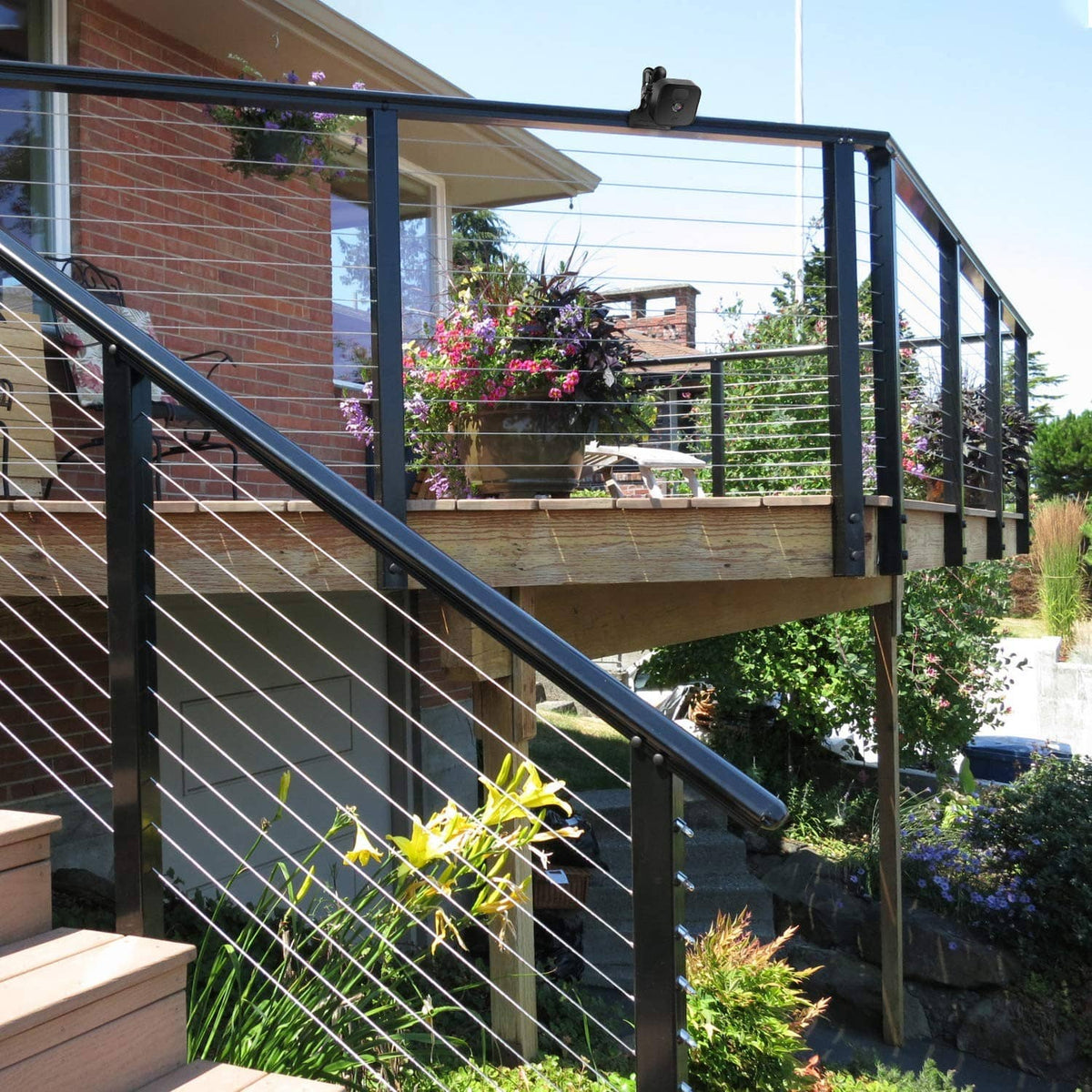 Black clip clamp mount holding a camera on a black balcony railing