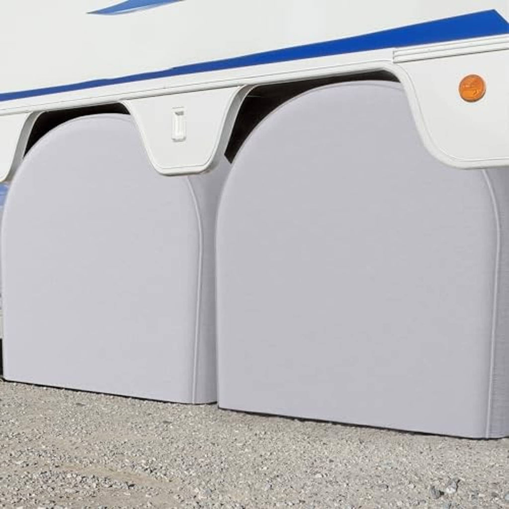 Light gray RV tire wheel covers installed on vehicle tires, arched panels