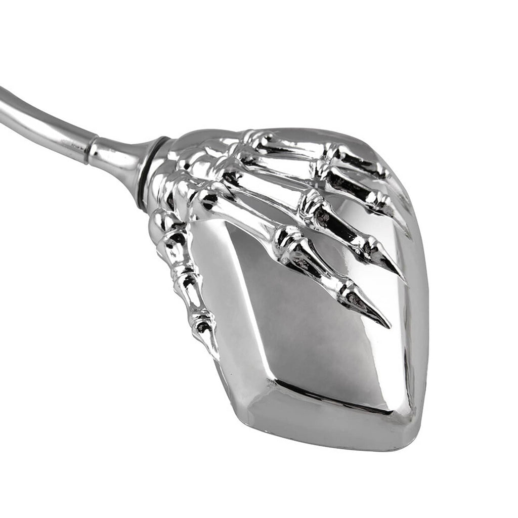 Close-up of chrome skull-hand motorcycle side mirror housing with rectangular glass