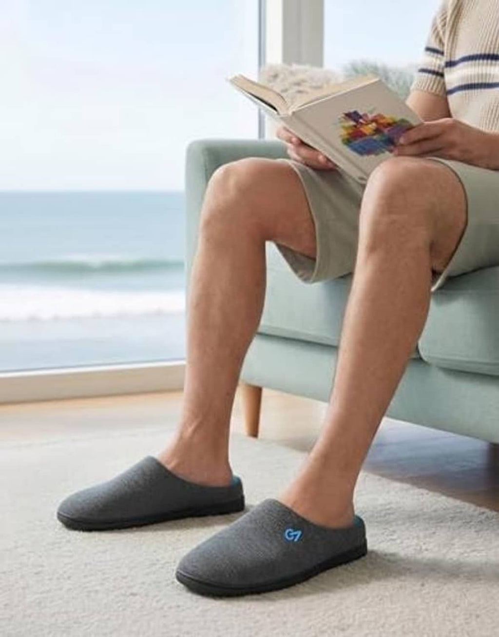 Men’s dark gray two-tone slippers with blue lining worn indoors