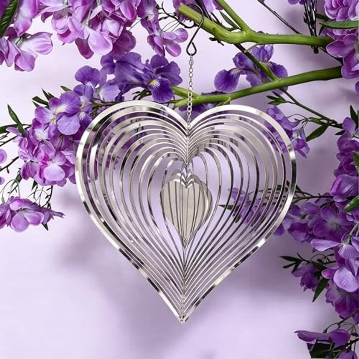Reflective silver heart wind spinner with hanging chain, layered curved metal spokes