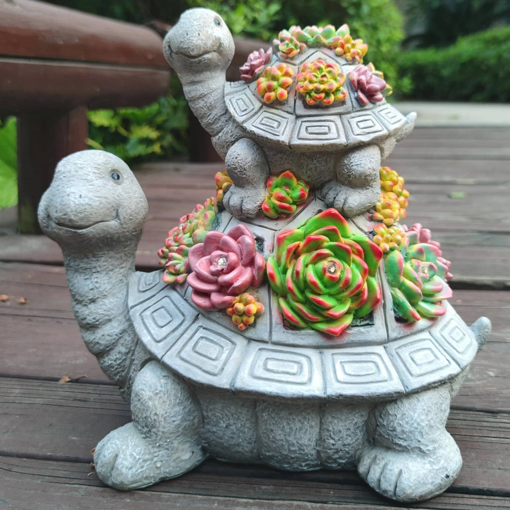Solar tortoise garden lantern statue with colorful flower decorations and small warm lights