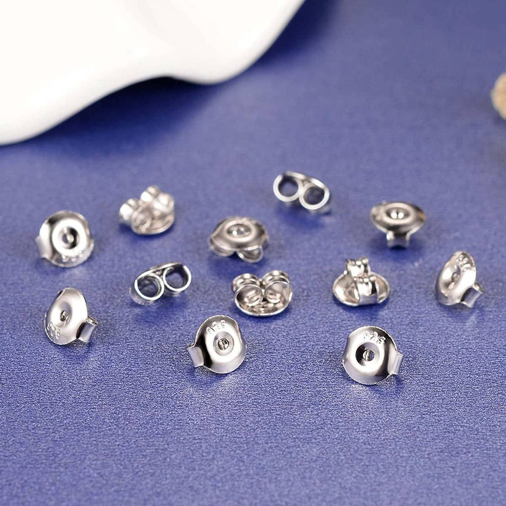 Assorted earring back replacements in silver and dark gold tone with push-post backs