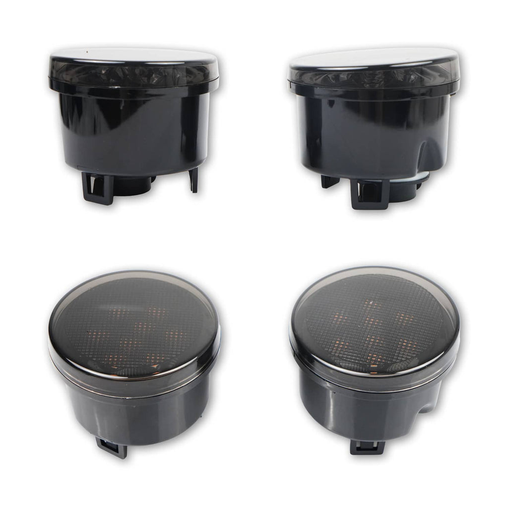 Pair of round black LED fog lights with smoke gray lens covers, bottom mounting tabs visible