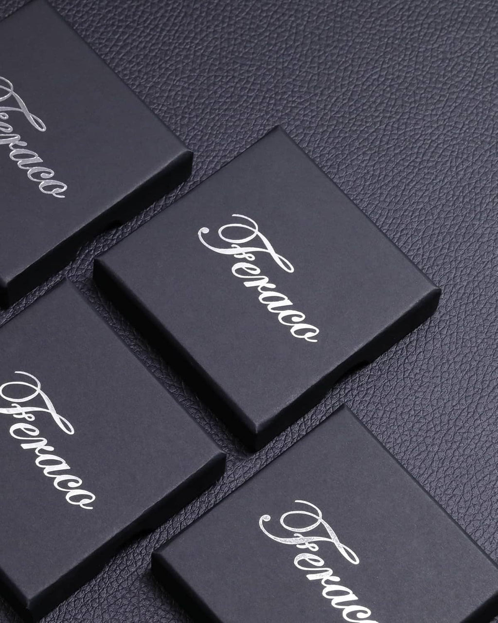 Feraco branded bracelet gift boxes on dark textured surface