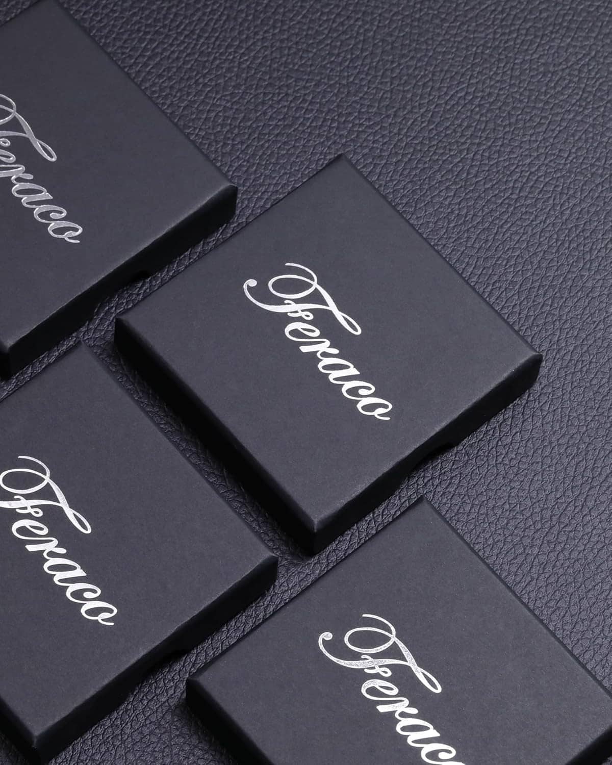Feraco branded bracelet gift boxes on dark textured surface