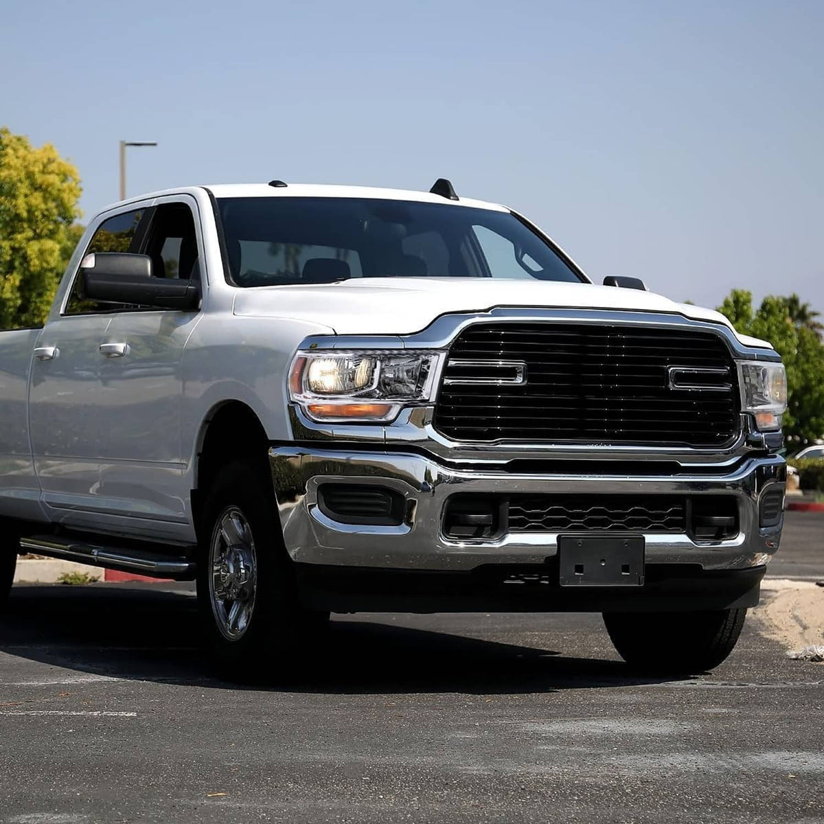 Right halogen chrome headlight installed on a silver pickup truck front