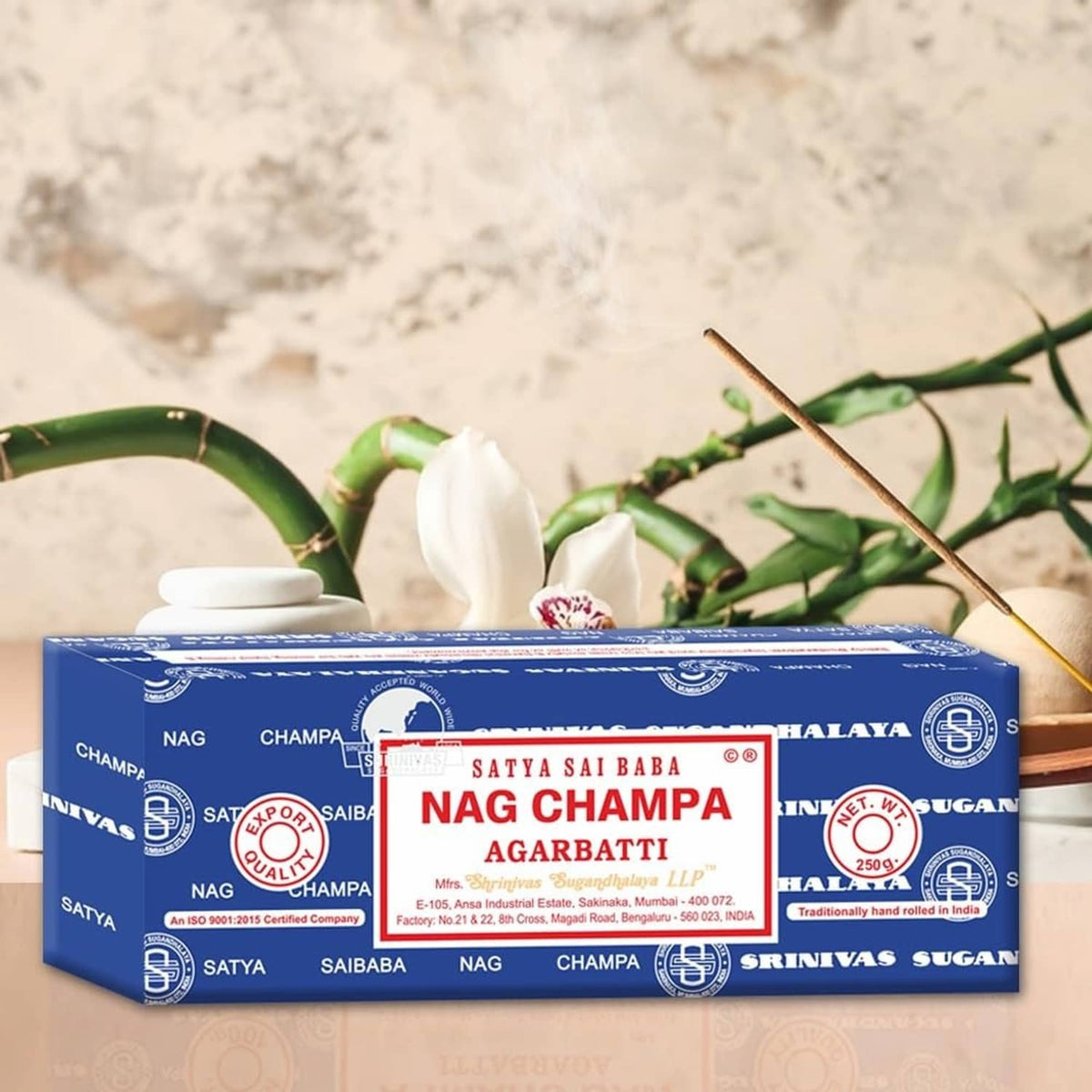 Nag Champa agarbatti box with nearby incense sticks and green stems