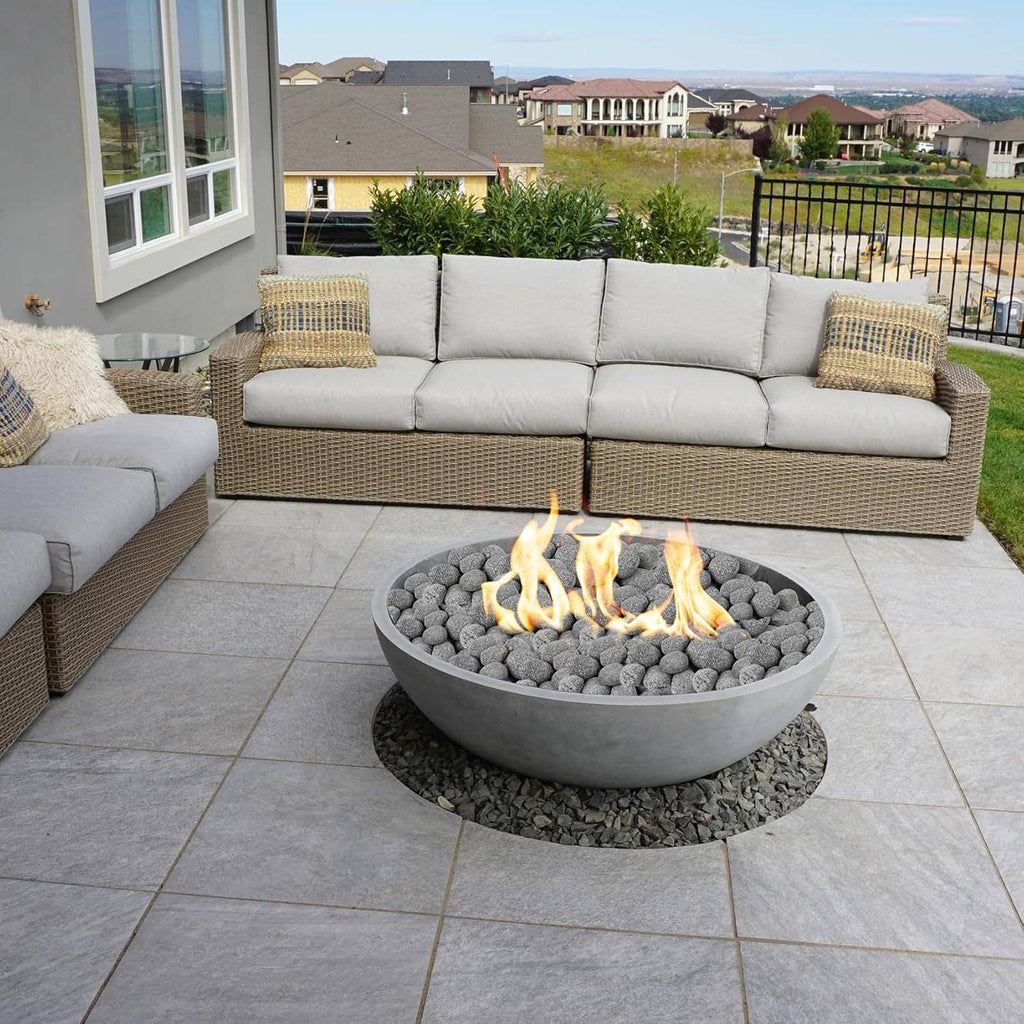 Black round lava rocks in a decorative outdoor fire bowl