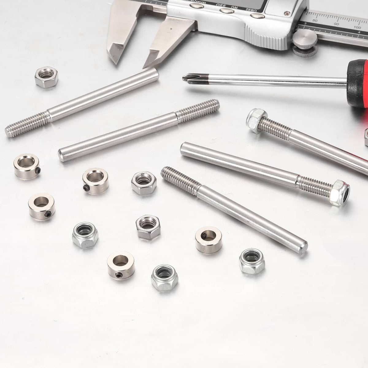 Silver steel axle shafts with nuts and washers, close-up