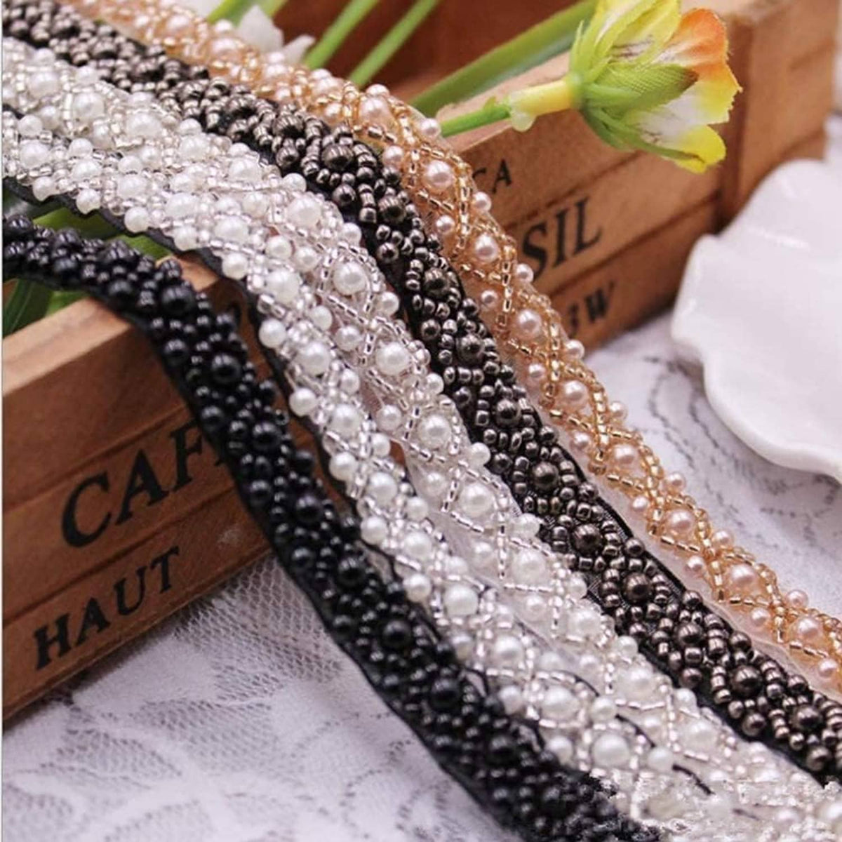 Beaded lace trim ribbons in white, black, and bronze tones with pearl rows