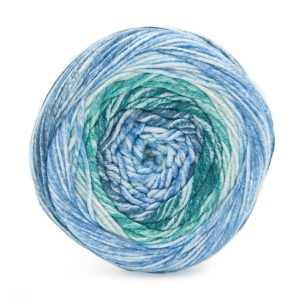 Lion Brand Mandala Ombré variegated yarn cake in blue, teal, and white