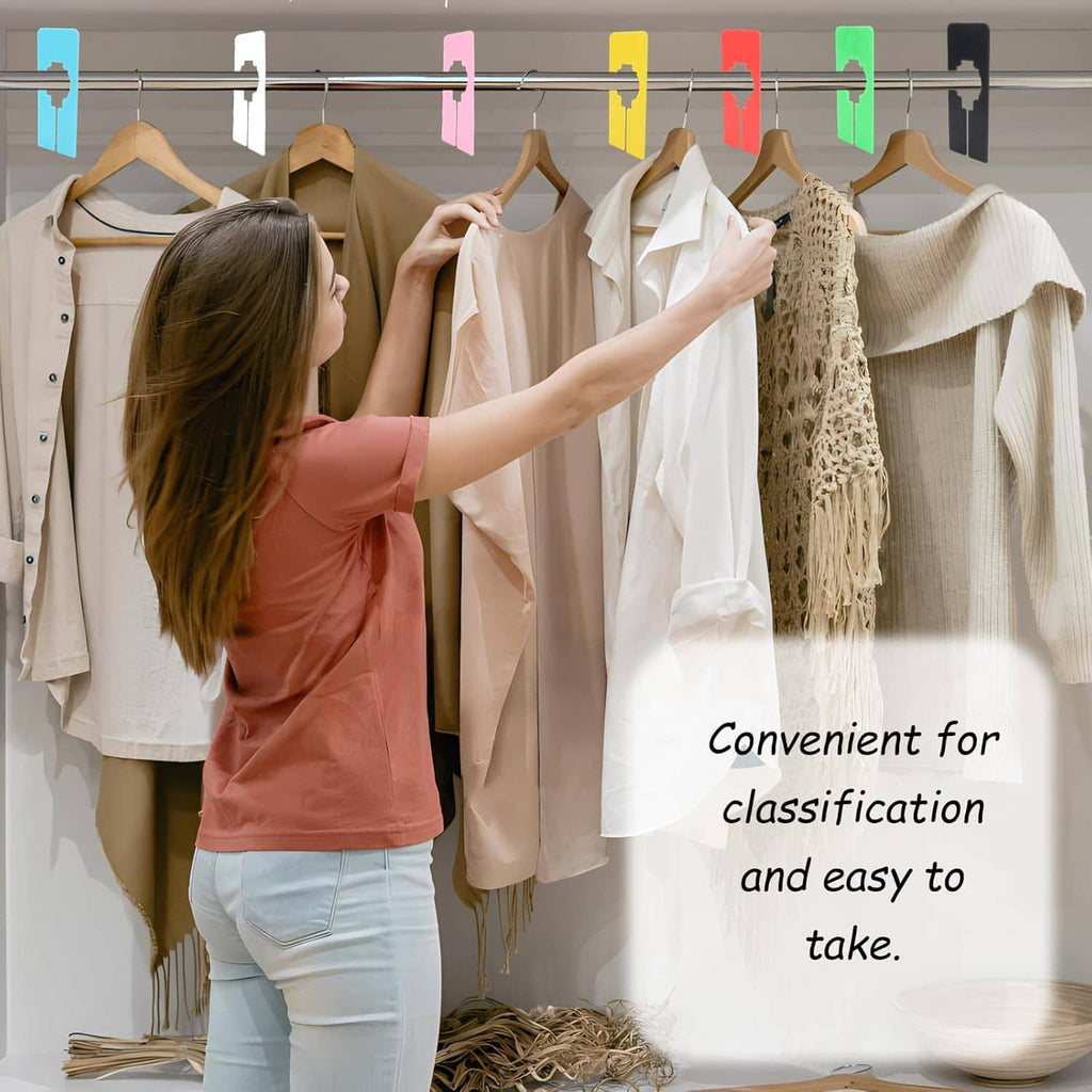 Person arranging shirts on a rack using plastic closet divider clips for classification