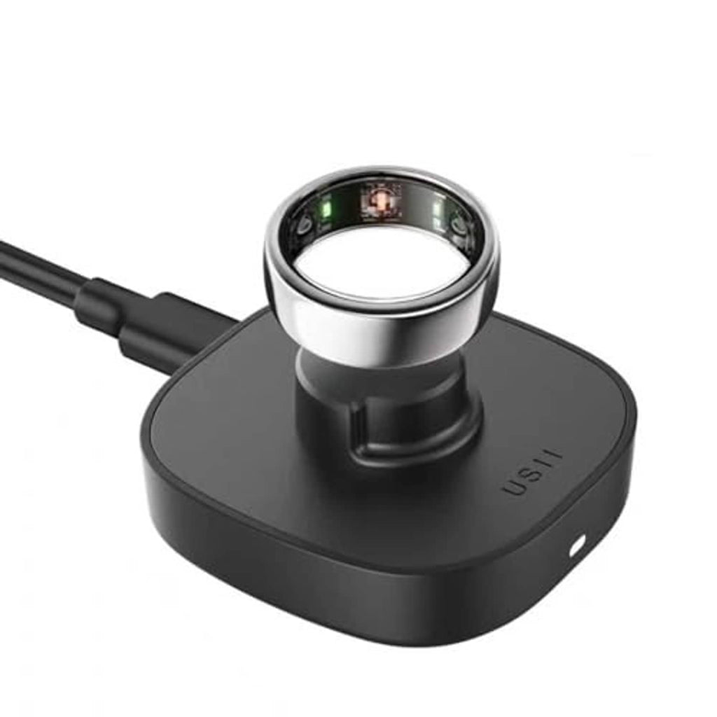 Black smart ring charging dock, angled view, USB-C cable attached