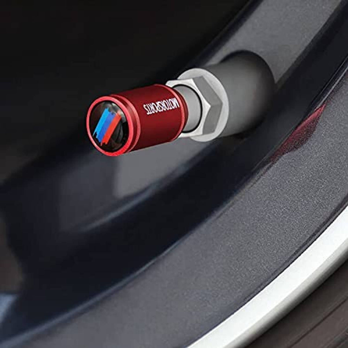 Red wheel valve stem cap with blue stripe insert and silver base ring