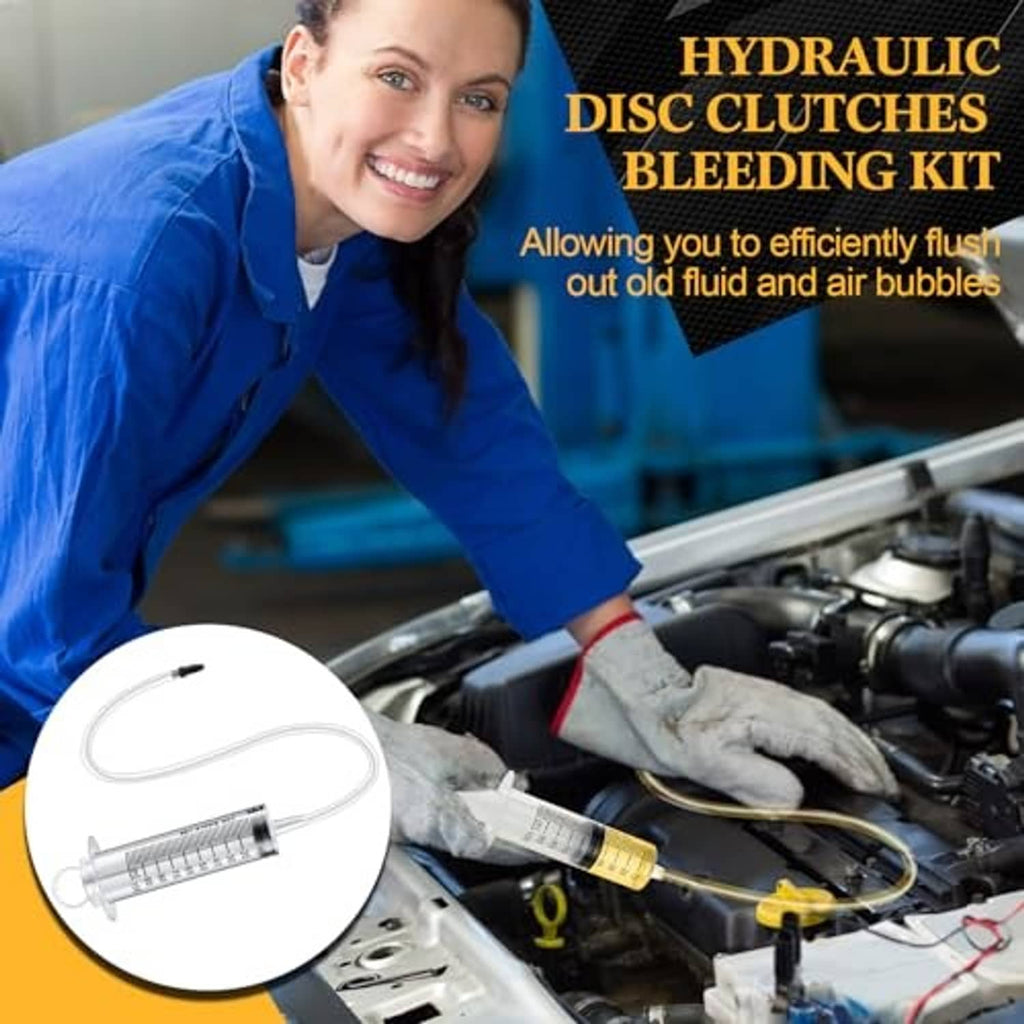 Hydraulic disc clutch bleeding kit with syringe and clear hose connected near motorcycle engine