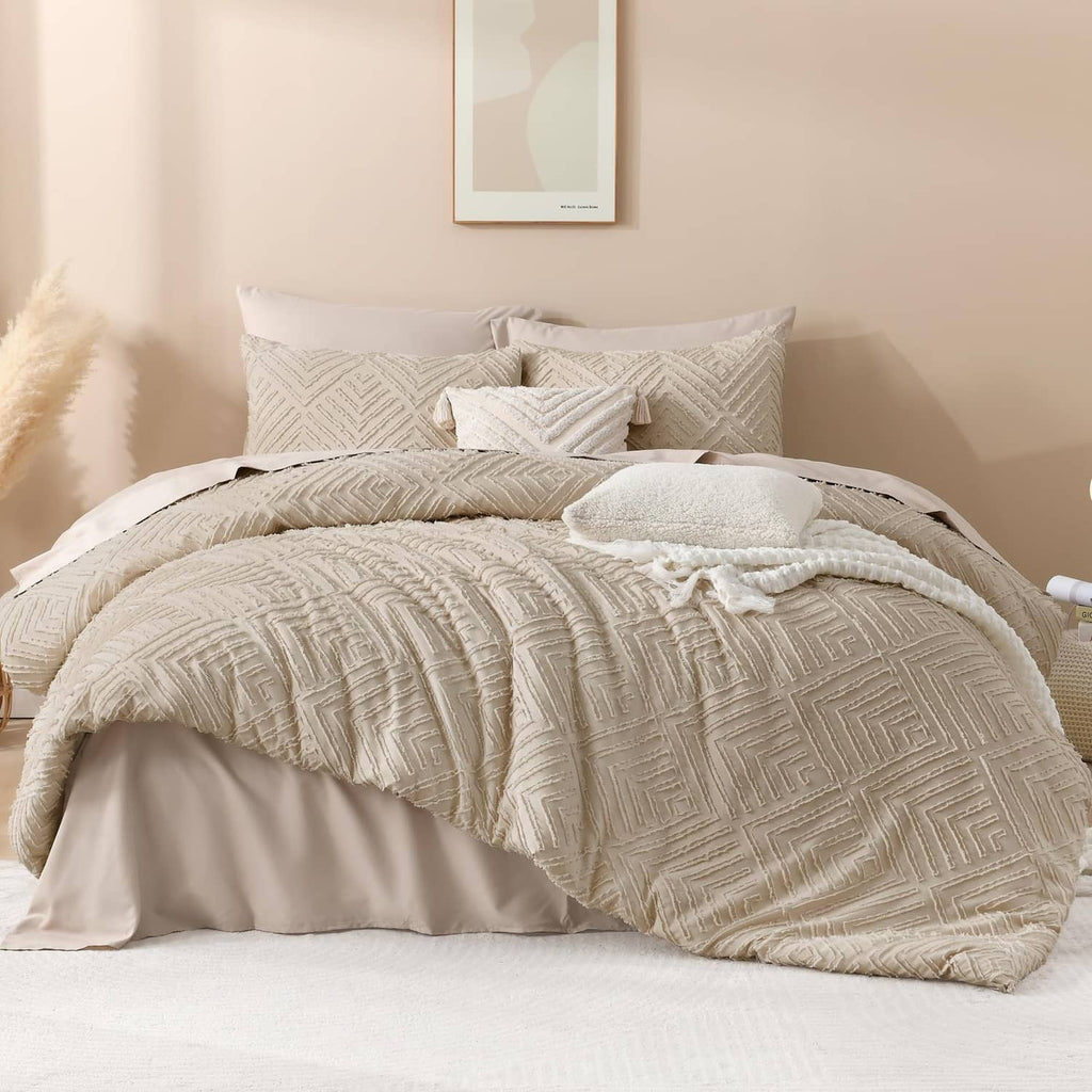 Light beige quilted comforter with repeating geometric pattern and two matching pillow shams