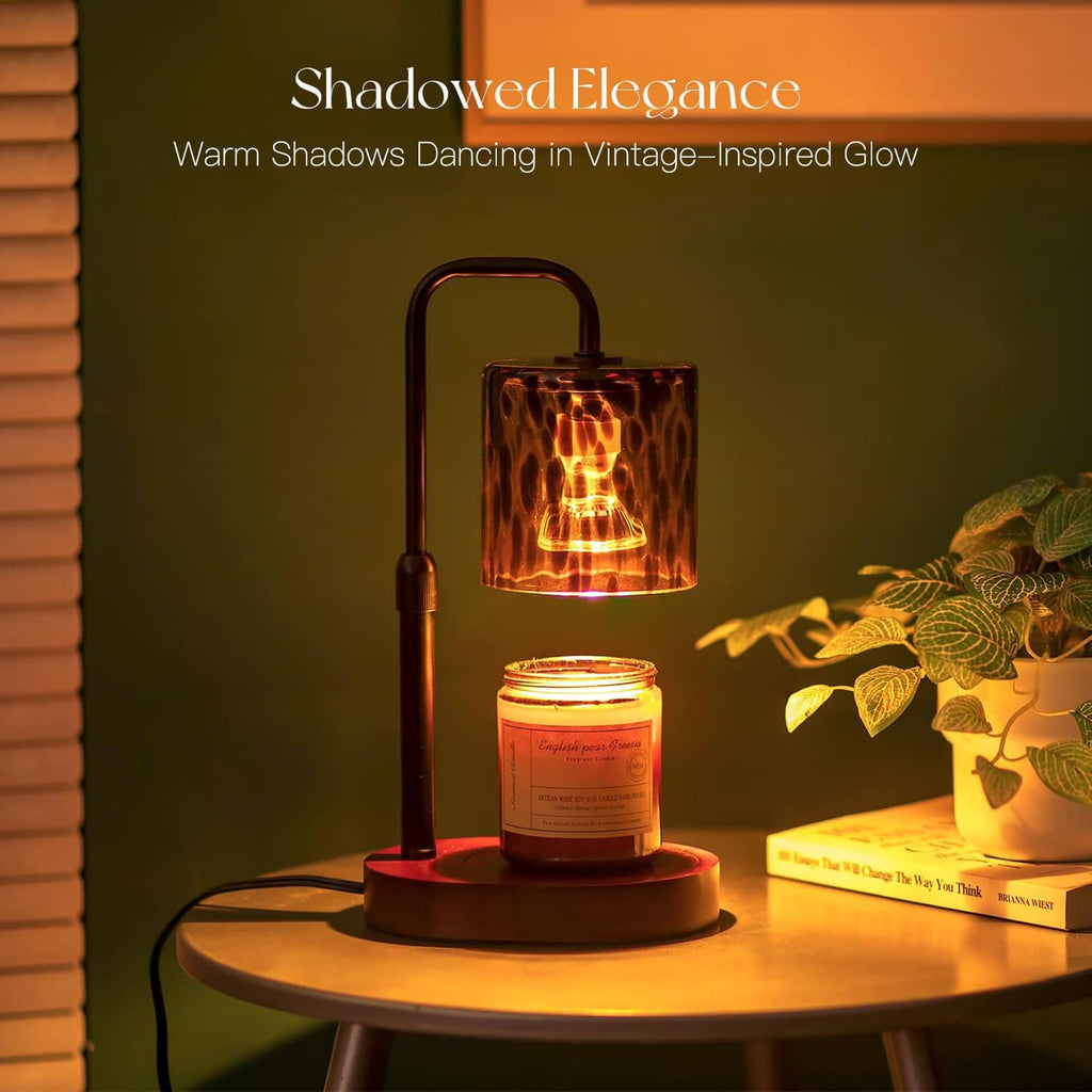 Candle warmer lamp with amber tortoise-shell glass shade, lit candle, and tall handle