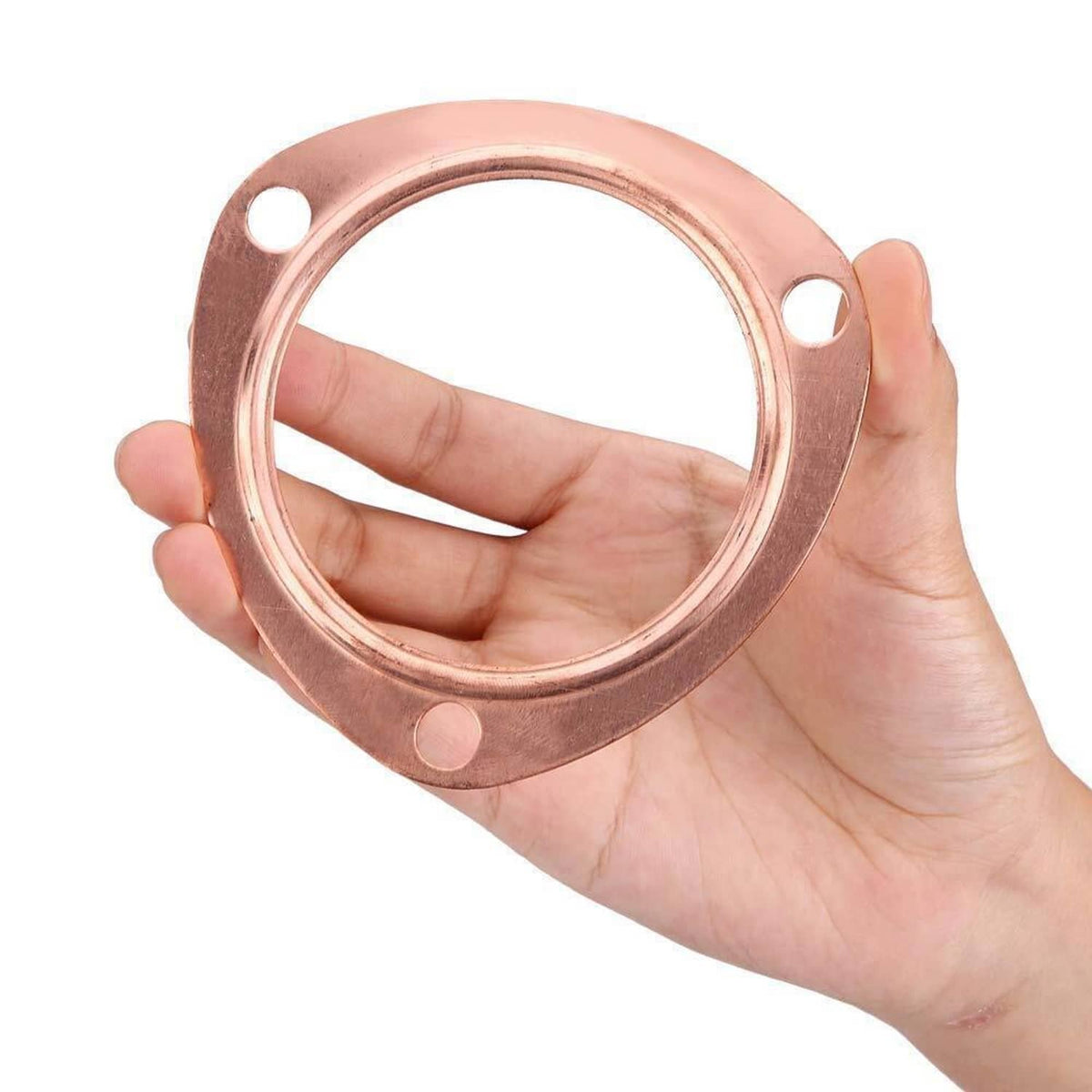 Copper exhaust collector gasket flange, round, held in hand, bolt holes