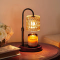 Black candle warmer lamp with glowing glass lantern shade and round base