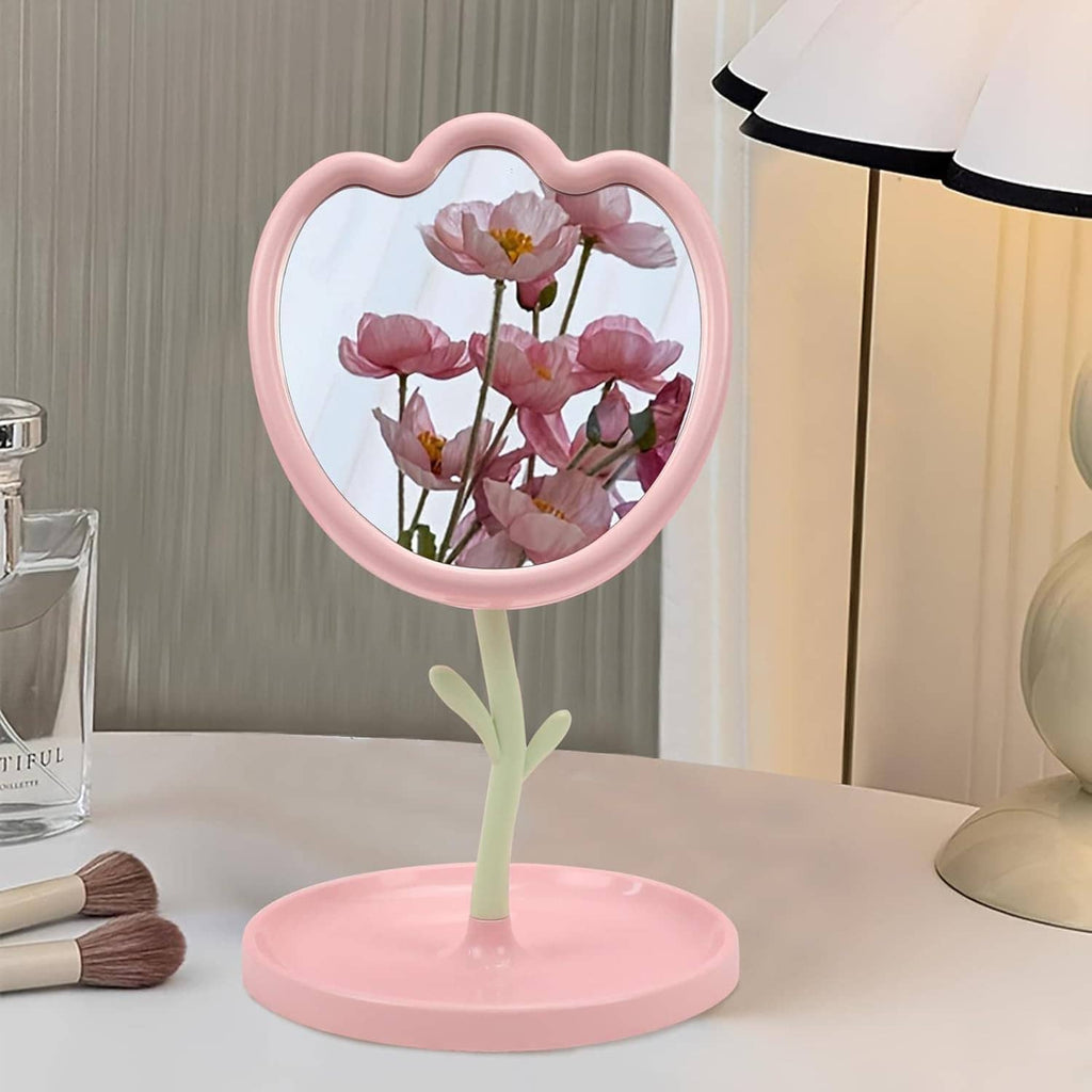 Pink flower-shaped tabletop mirror with round base and floral reflection