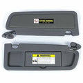 Dark gray sun visor pair with Air Bag warning labels and mounting brackets