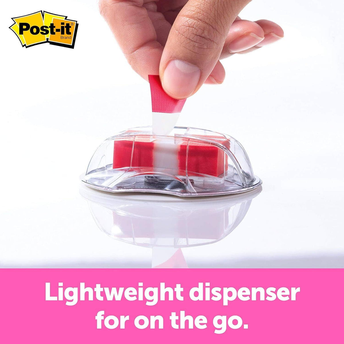 Hand pressing a red sticky note into a desktop sign dispenser with clear cover