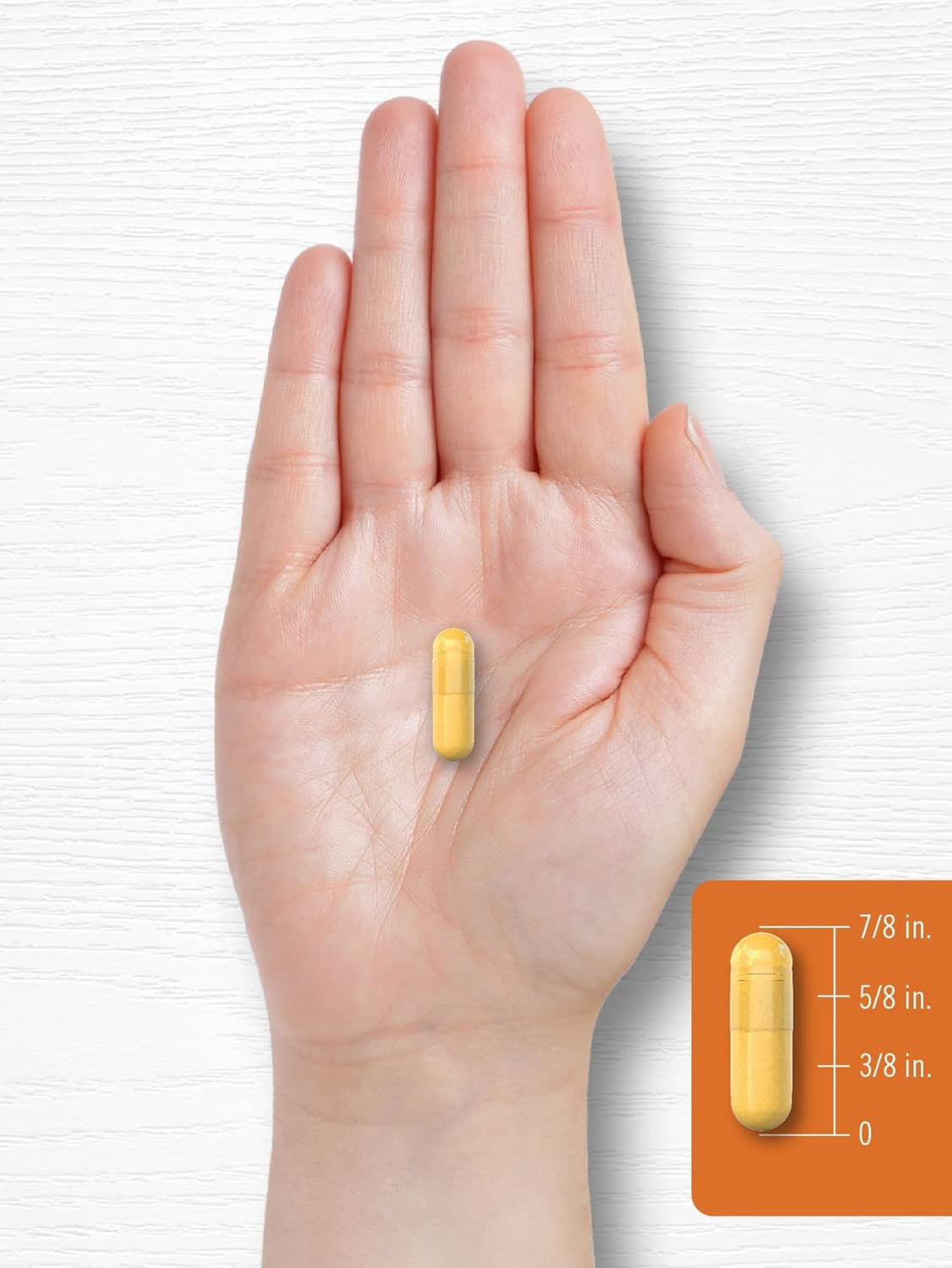 Turmeric curcumin complex 1000mg capsule in open hand, 7/8 in size shown