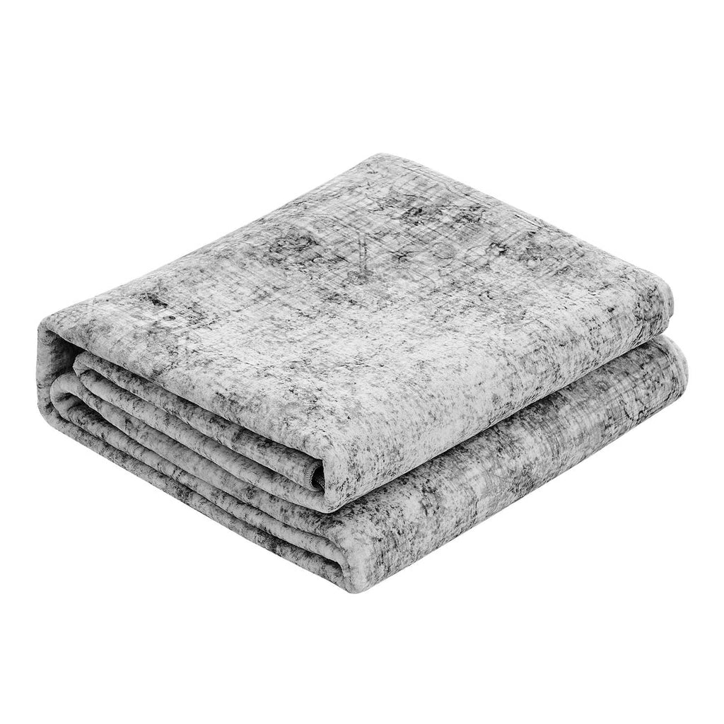 Folded gray area rug with distressed texture, low-pile surface