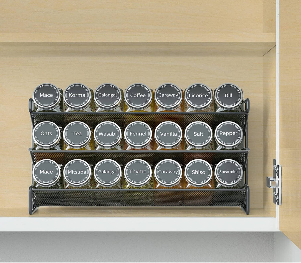 Black spice rack organizer with 21 labeled jars on cabinet shelf, front row visible