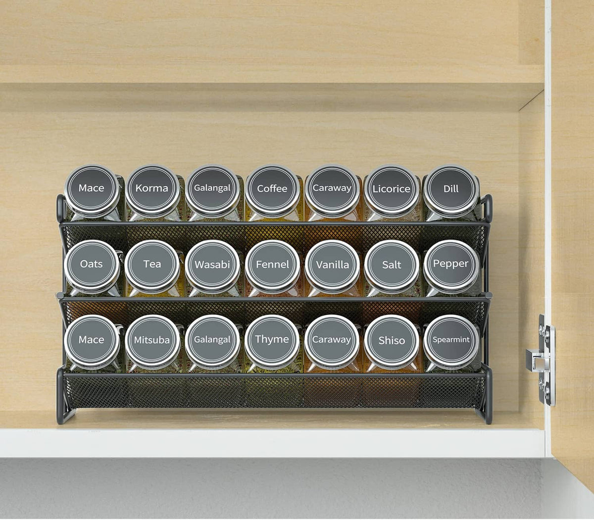Black spice rack organizer with 21 labeled jars on cabinet shelf, front row visible