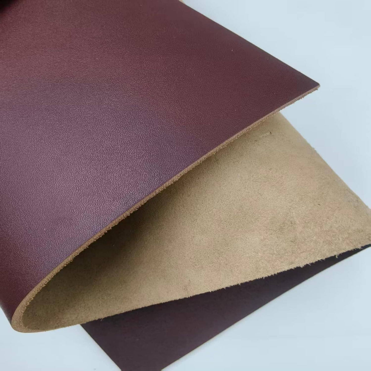 Brown leather sheet with exposed tan underside along the curved edge