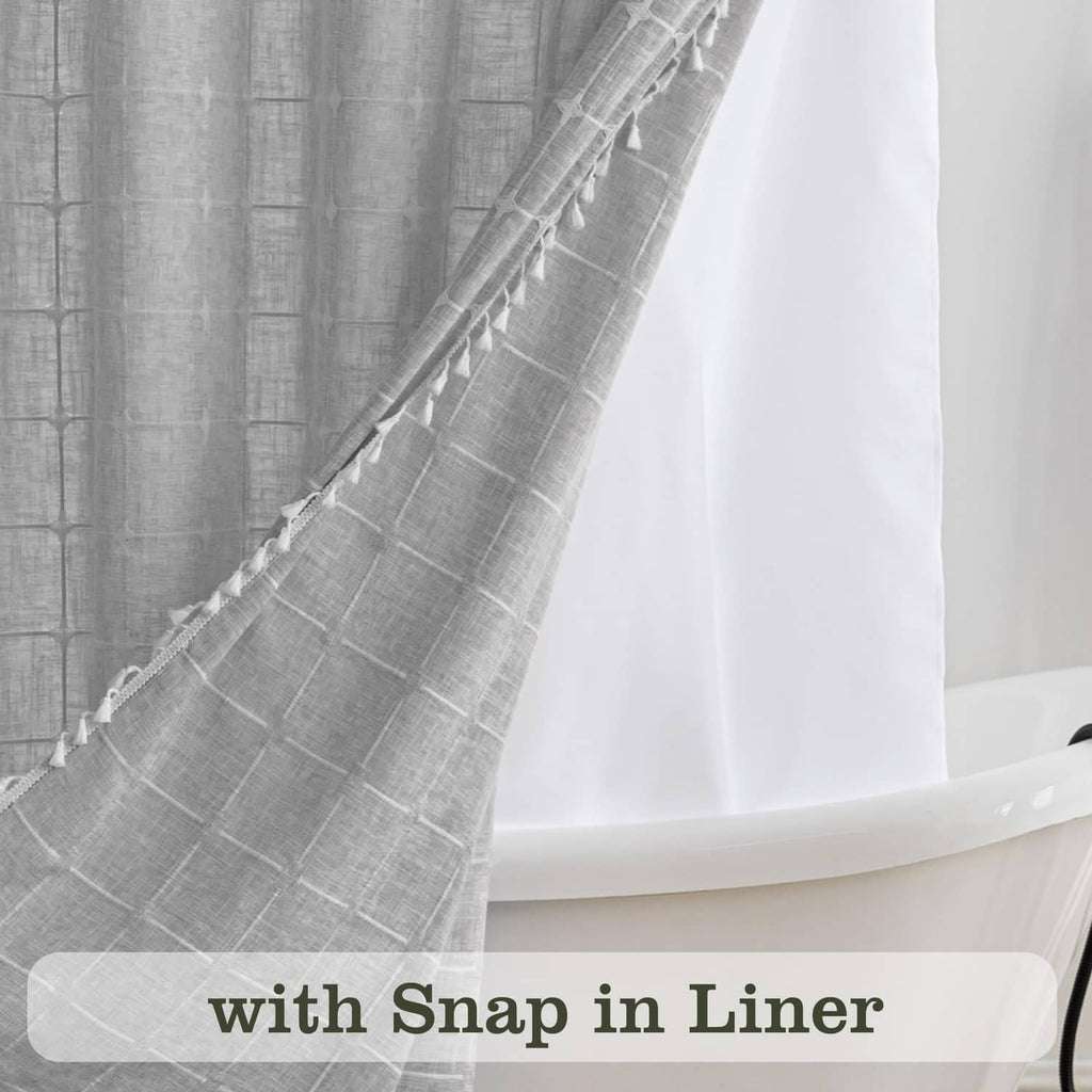 Grey mesh window panel on a white and grey shower curtain with tassels