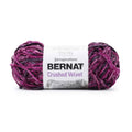 Bright magenta crushed velvet yarn skeins with wrapped label, bulky weight.
